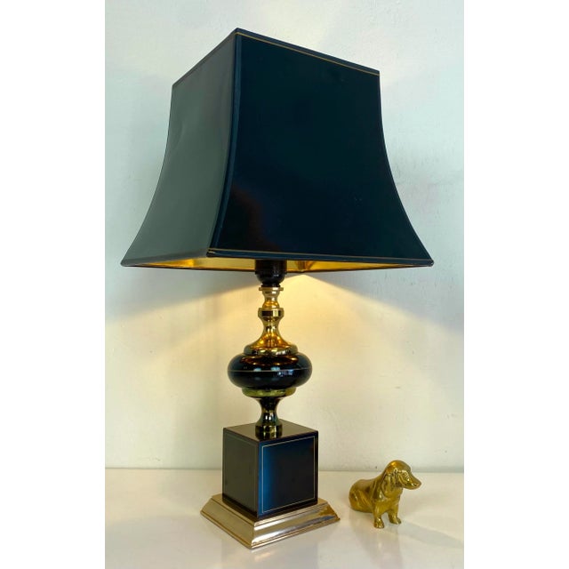 A sophisticated table lamp, black with gold colored edges, created by Maison le Dauphin France. This classic lamp will be...