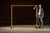 Yellow industrial garment rack on casters. Constructed from painted steel pipe with threaded joints, this utilitarian...