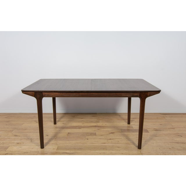 A rare model of a rectangular table with two mechanically extensions, made of teak wood by the British McIntosh...
