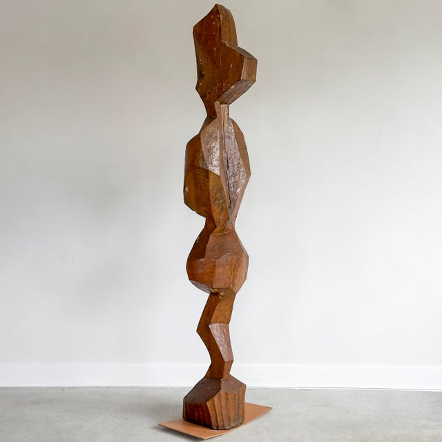 Carved wood floor sculpture of an abstracted figure. Unknown artist.