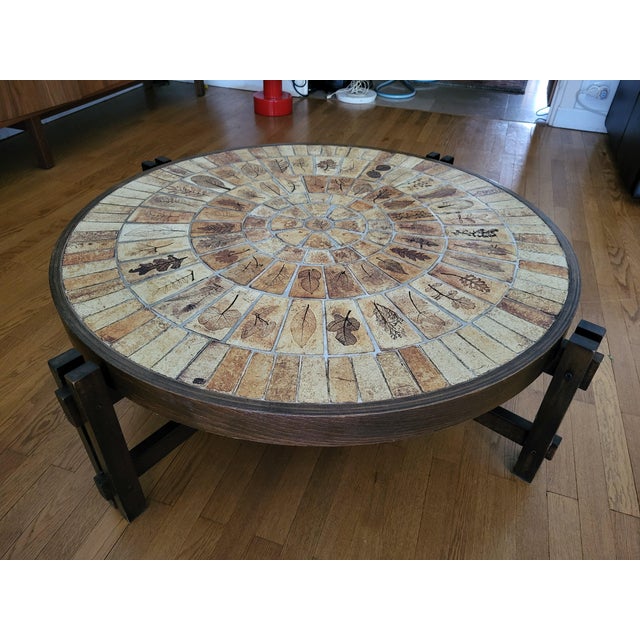 Roger Capron's "Herbier" coffee table is an iconic piece of 1970s design, featuring a sophisticated wooden base designed...