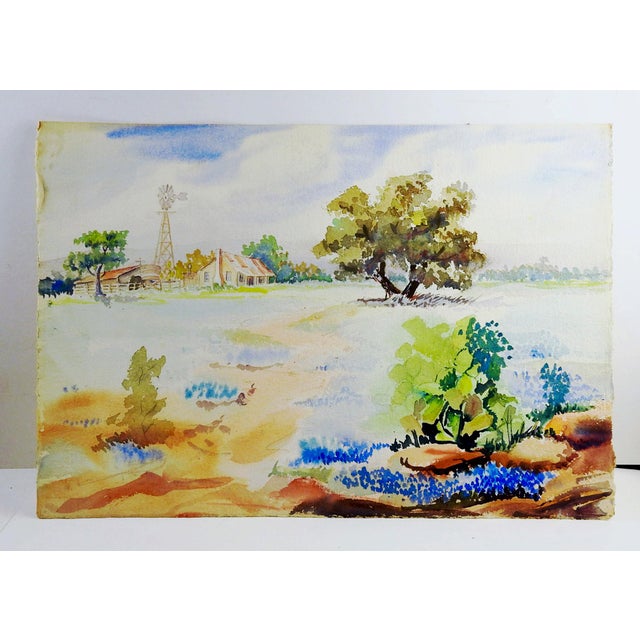 Late 20th century watercolor on paper of Texas hillcountry landscape with old ranch, bluebonnets and cactus. Unsigned....