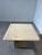 Elegant and timeless vintage travertine side table, dating from the 1970s. The design features a square tabletop with...