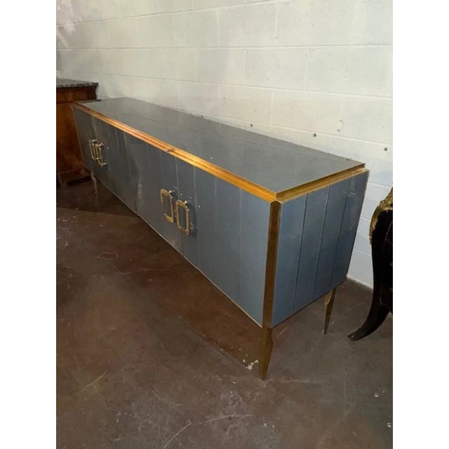 The Modern Gray Murano Glass and Brass Sideboard is a stylish piece of furniture for the home. This sideboard features...