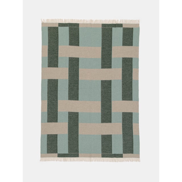 Cashmere and wool blanket with woven pattern.