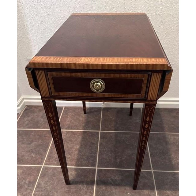 This Pembroke table is made out of mahogany wood crafted with dovetailed drawer construction. It is offered with high-...