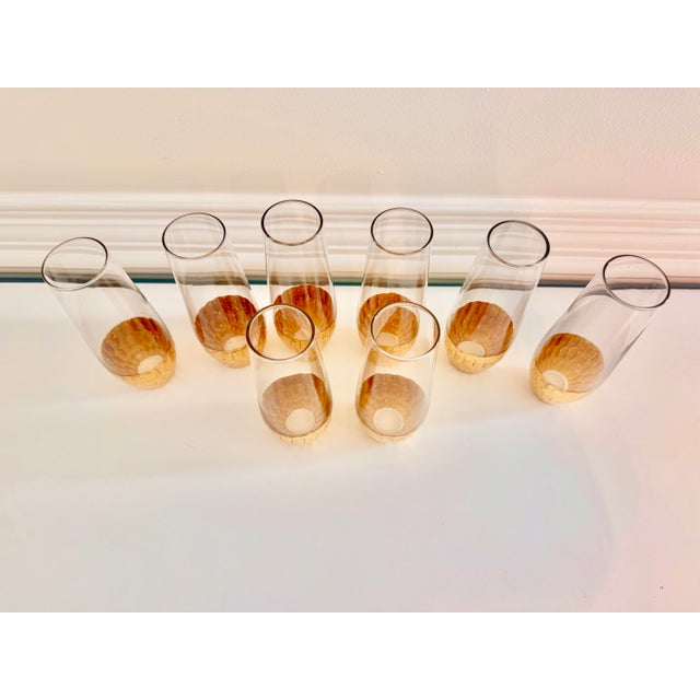 Elegant and versatile set of eight clear glass vessels accented with hand-applied gold leaf. Their slender, contemporary...