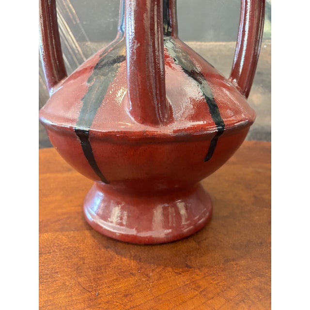 Striking oversized studio pottery vase with dramatic double-loop handles and a rich oxblood red glaze. Likely late 20th...