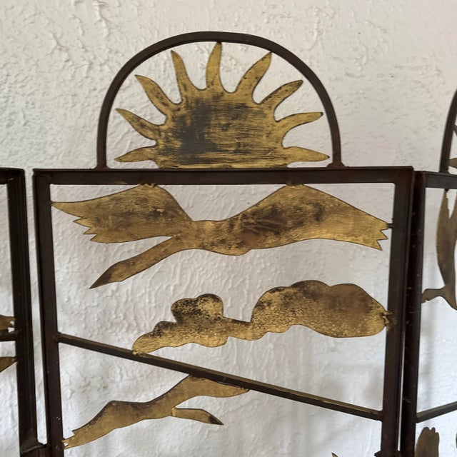 An antique hand cut metal folding screen/ room divider with an iron frame with openwork brass figures, animals and trees...