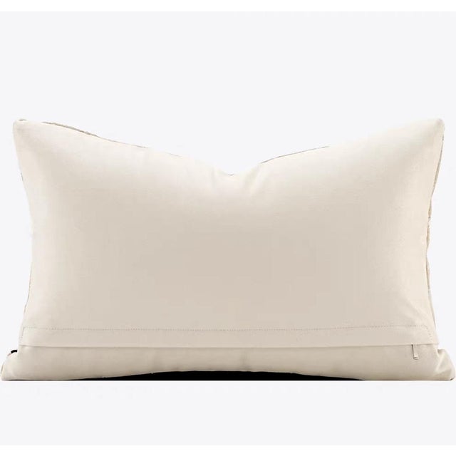 This golden leather-stitched throw pillow captures light with irregular geometric cuts, and the rough stitching texture...