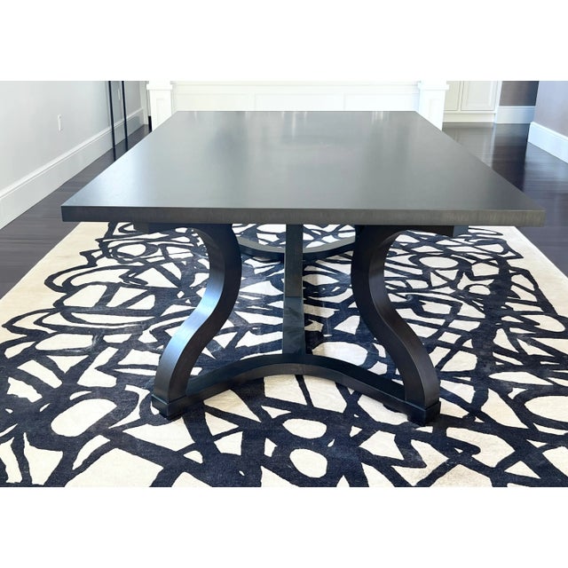 Christian Liaigre “Misaine” dining table in solid, open grain oak with four curved legs. This dining table has been barely...