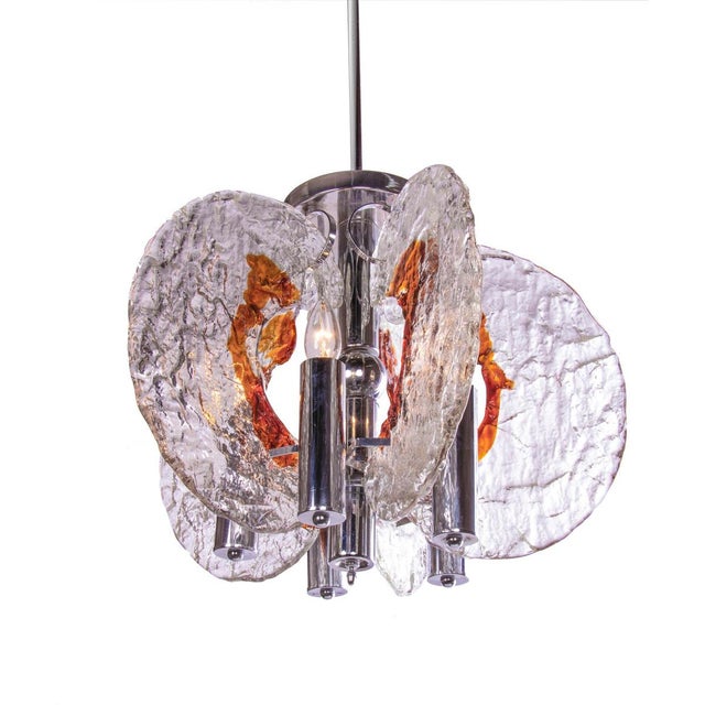 Elegant pendant light with smoked and clear murano glass elements with amber details on a chromed brass frame....