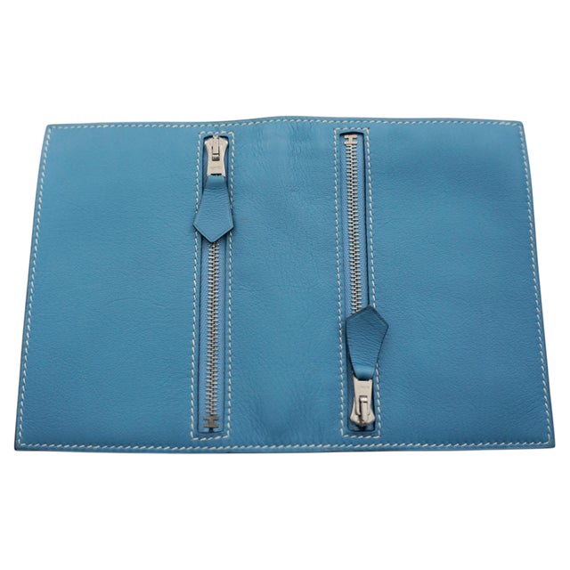 Embrace effortless elegance with the Hermès Blue Jean Swift Zip Compact Wallet, a perfect accessory for stylish...