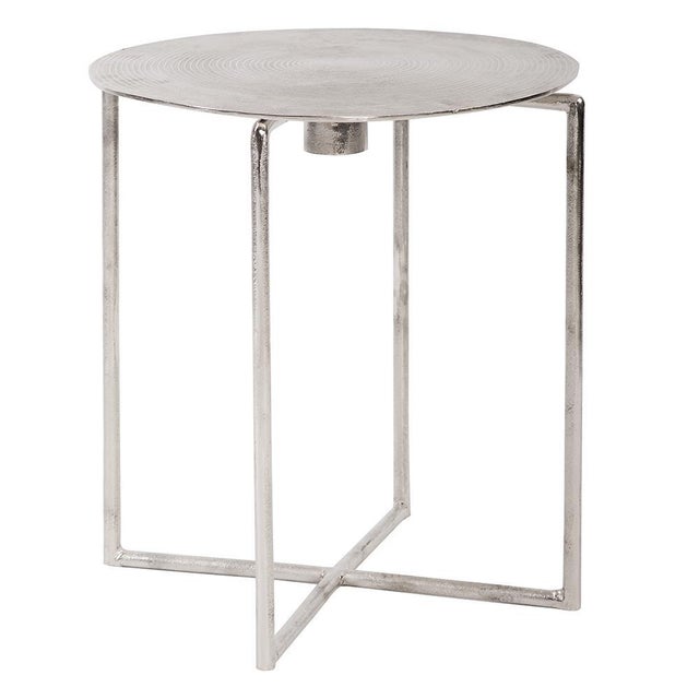 This simple round accent table is fashioned from aluminum metal with a criss cross base. The table top of the piece is...