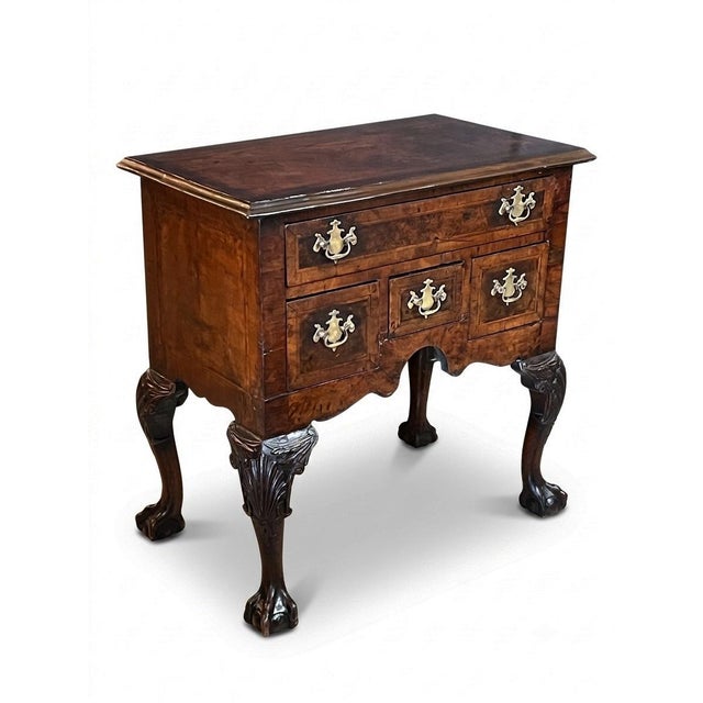 the rectangular top above a conforming body featuring a single long drawer set above three smaller, side-by-side lower...