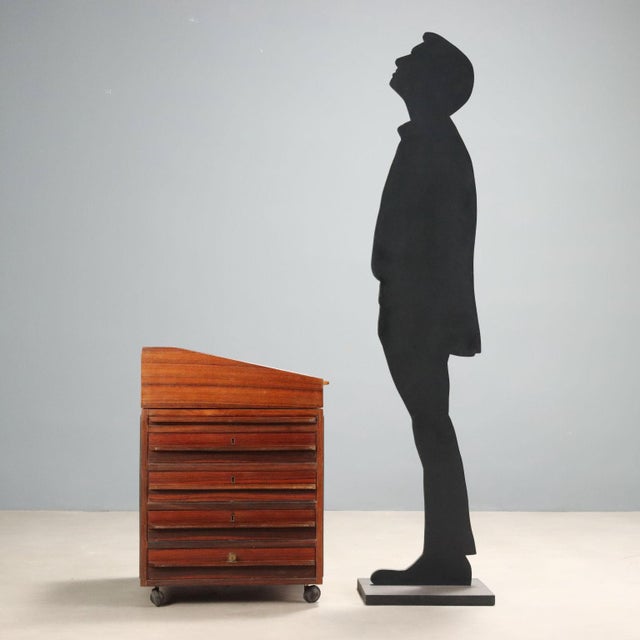 1960s chest of drawers with desk, featuring a veneered wood structure with exotic woods. The surface is enhanced by panels...