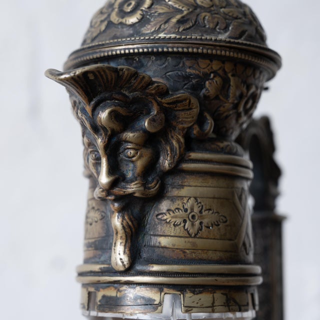 An English Victorian cut crystal flagon with bacchic face spout, circa 1890. 5 ½ inches wide by 5 inches deep by 12 ½...