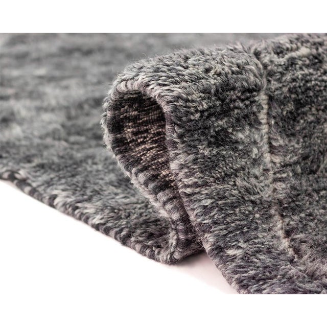 Luxurious Charcoal Grey hand-knotted wool rug, accented with a hand-woven Ivory diamond pattern, brings a sophisticated...