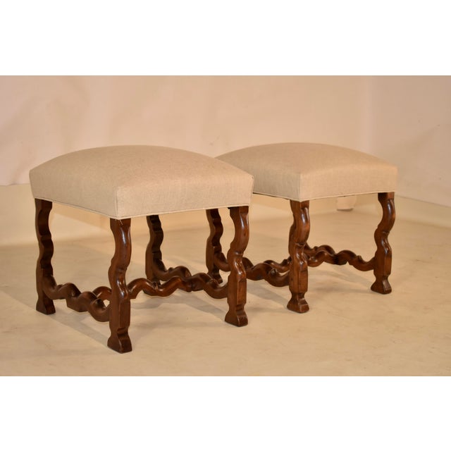 Pair of 19th century walnut stools from France with mouton legs. These stools are so elegant and have a beautiful profile...