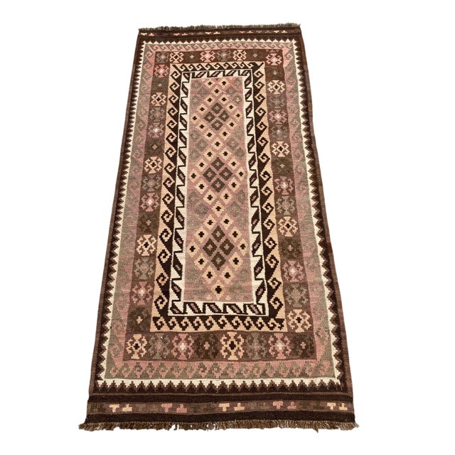 A small handwoven Maimana kilim from northern Afghanistan, worked in dusty mauve, sage green, cream and chocolate brown....