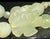 A central hand-carved prehnite floral/flower pendant focal point displaying prehnite's classic translucent pale apple-...