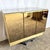 This dazzling postmodern credenza features a sleek smoked-mirror façade framed in polished gold, delivering instant...