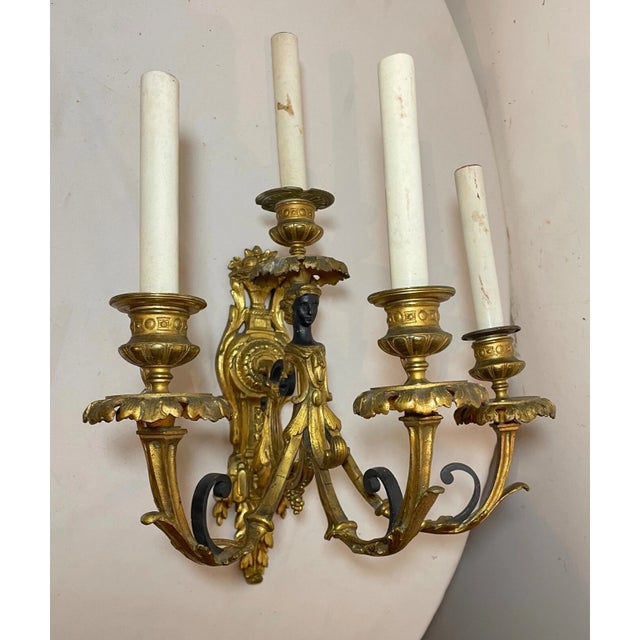 Up for sale is a large antique 19th century solid two toned bronze bronze figural wall sconce. It has once a candle holder...