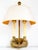 A vintage brass wall lamp in a neoclassical style with bouillotte influences, pairing two candle-style lights with a...