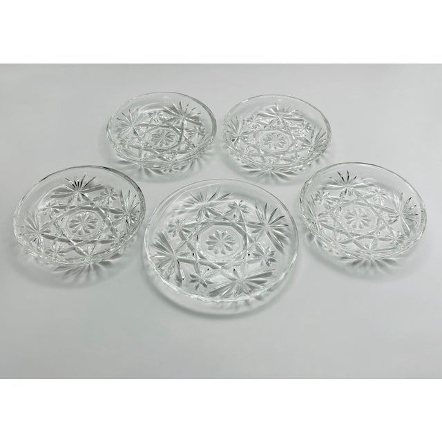 A charming set of classic pressed glass coasters in excellent condition. These pieces are durable, stackable and washable....