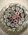 A lovely example of murano glasswork. It has a colorful pastel confetti base with blue and burgundy flowers. A nice accent...