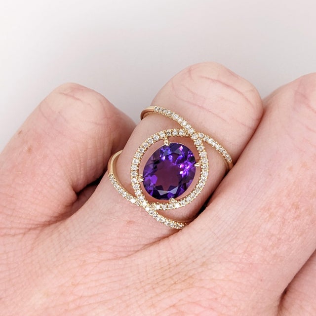 This gorgeous statement ring has an elaborate split shank design and features a gorgeous 10x8mm oval amethyst from Uruguay...