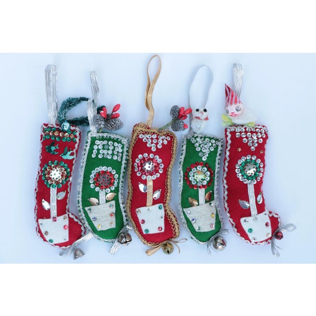 This set of felt Christmas stocking ornaments is ready to decorate your tree this holiday season. Handmade in the early...