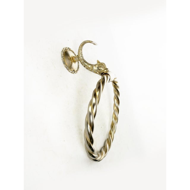 Twisted metal wall-mounted towel rack with decorative bracket, made in France in the 1970s. This vintage towel rack is...