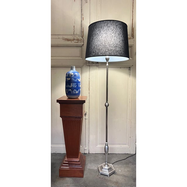This French 1940s silver plated floor lamp is a timeless piece that is sure to add vintage charm to any space. Its hand-...