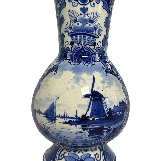 Antique hand-painted Delft Blue vase by Royal Delft / De Porceleyne Fles, made in Delft in 1916. The vase has a rounded...