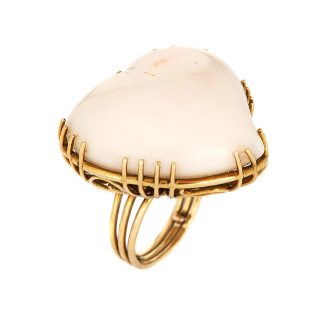 Stylish vintage huge angel skin coral heart cocktail ring (circa 1960s) crafted in 18 karat yellow gold. Angel skin coral...