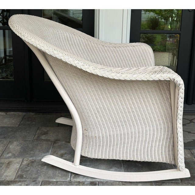 Vintage all-weather wicker rocking chair, attributed to Lloyd Flanders Reflection collection, with cushions as shown....