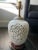 A gorgeous ginger jar lamp with a unique depiction of a deer in a bed of cherry blossoms. On one side the deer is eating...