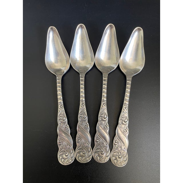 A stunning set of four fruit/orange spoons in the Royal pattern by Aurora Silver Plate Co. / International Silver. This...