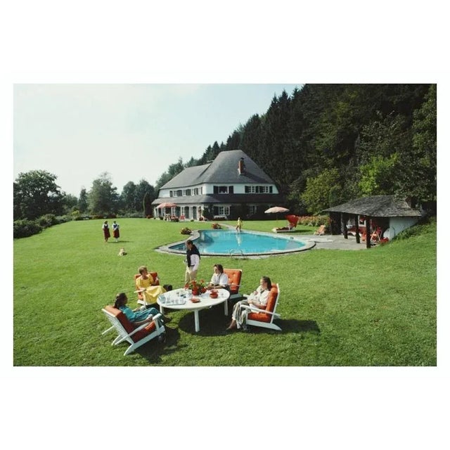 Von Oswald House 1986 group of people relax in the garden at the house of Johanna Von Oswald, 1986. Slim Aarons Slim...