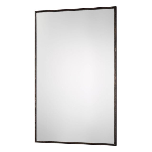 Stylish and clean design featuring a plain mirror that is slightly set in from the frame, appearing as if the mirror is...