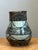 This vintage studio pottery vase showcases a confident hand-painted geometric motif in deep slate and charcoal tones set...