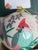 This is a large glass ornament. It is reverse painted, featuring a beautiful cardinal in pastel colors. Box included....