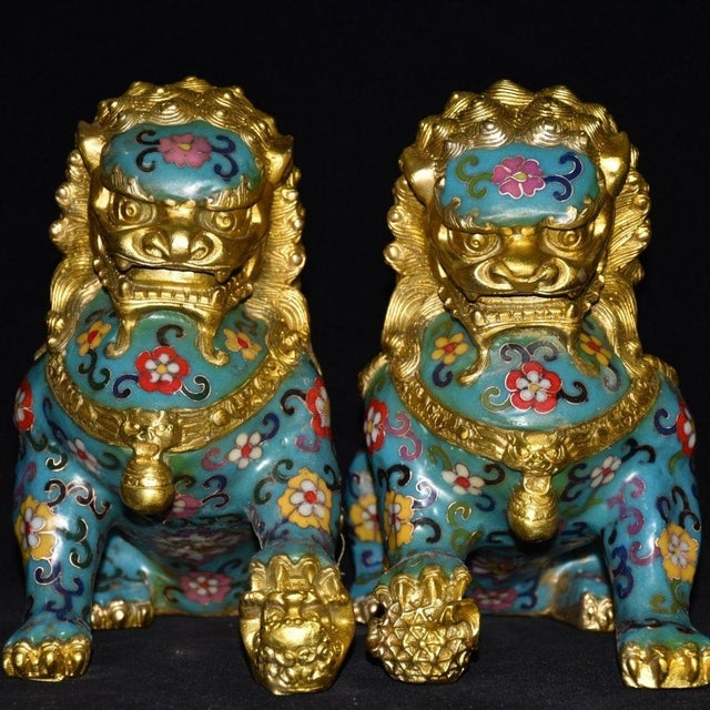This is a matching pair of vintage guardian lion (often referred to as Foo Dog) statues, crafted from copper with...