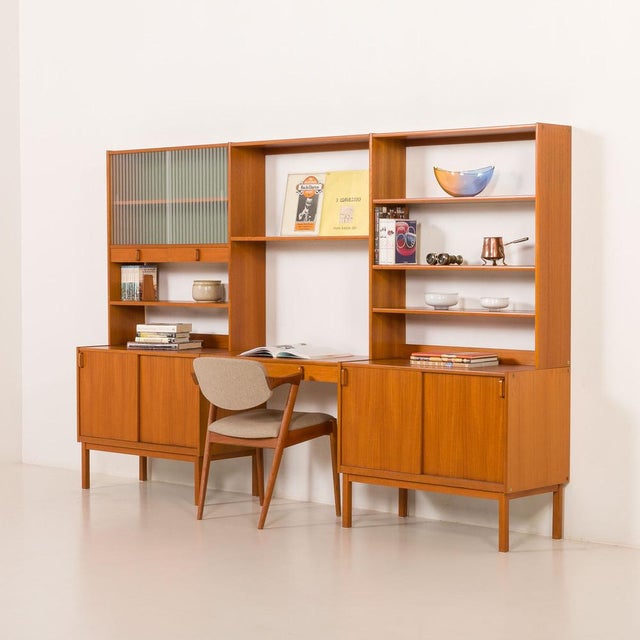 This elegant scandinavian wall unit was designed by bertil fridhagen and made by bodafors in the 1960s. It is a refined...