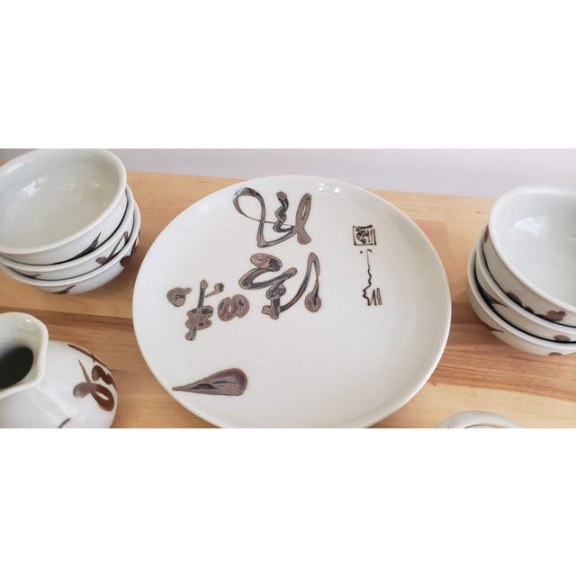 This is a beautiful set of six bowls and various servings pieces. It's ceramic with a calligraphy design. These pieces are...