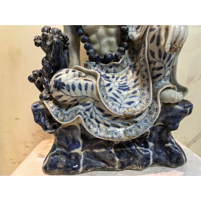 W-21cm,H-31cm This hand-carved blue and white porcelain statue depicts The Eighteen Arhats, a traditional Chinese Buddhist...