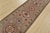 A tribal Caucasian Kazak runner hand-knotted with fine wool on a cotton foundation. This rug features a row of geometric...