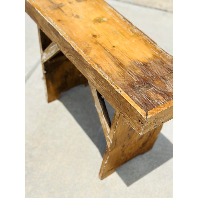 A charming antique Hungarian pine bench featuring a beautifully timeworn patina and simple provincial craftsmanship....