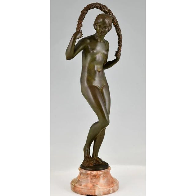 Art Deco bronze sculpture nude with garland by Joe Descomps Cormier. Patinated bronze on marble base. France 1925. This...
